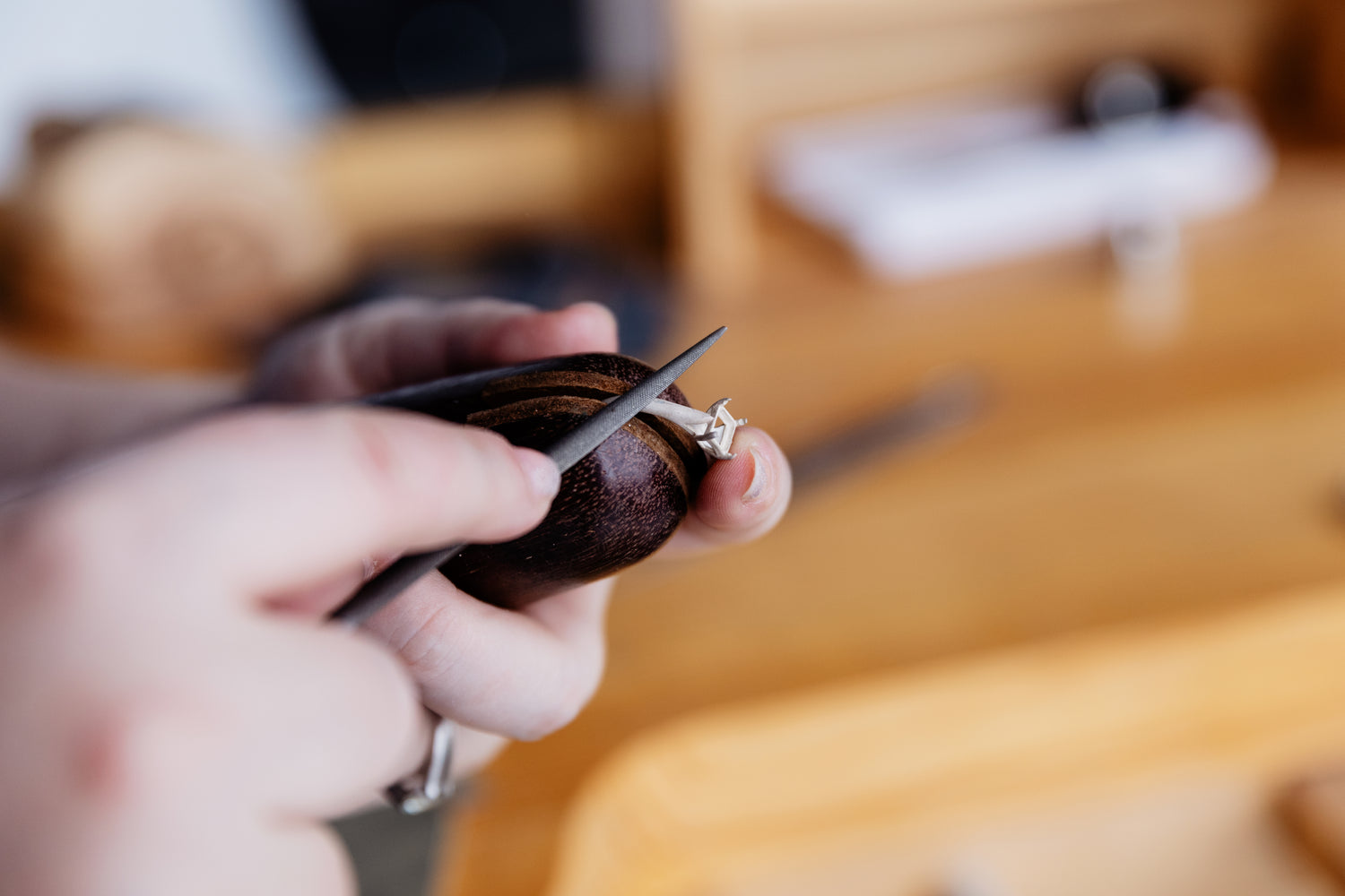 jeweller filing a ring