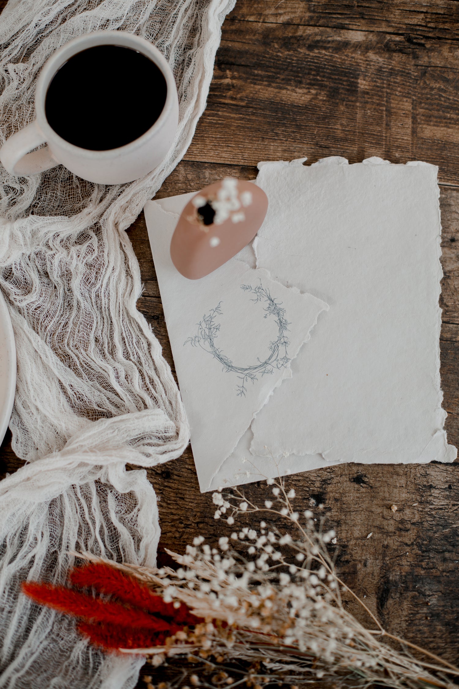 a sketch of a piece of jewellery on a wooden table
